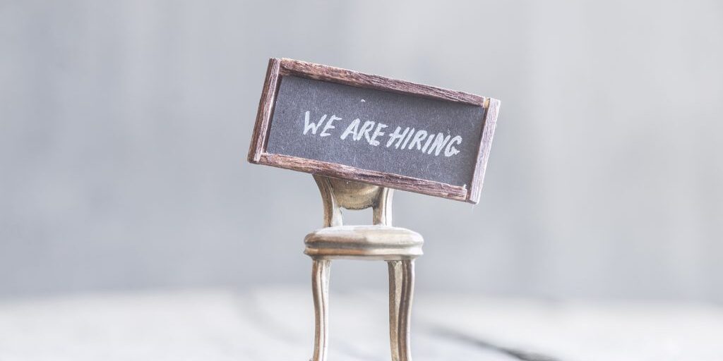 text We're hiring, the inscription on the label and golden chair